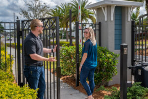a man opening a gate system for a resident